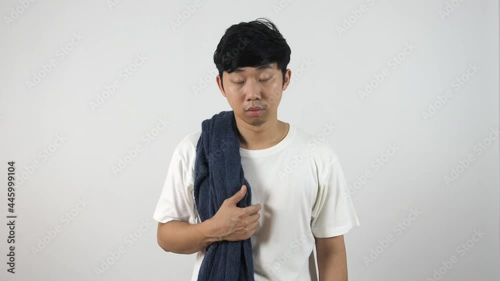 Asian man with towel wake up at morning feeling sleepy and yawn on white isolated background,Lazy man concept Asian man with towel wake up at morning feeling sleepy and yawn on white isolated background,Lazy man concept