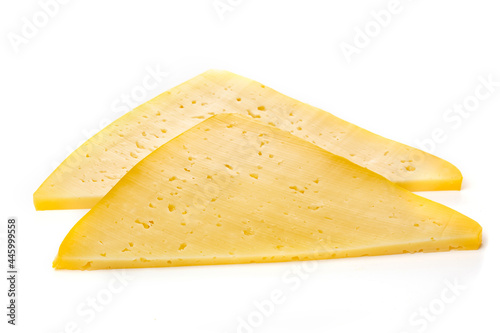 Pieces of semi-hard or hard yellow cheese with holes isolated on a white background.