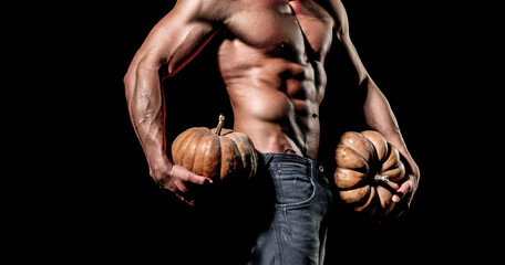 Halloween sale and shopping. Fashion guy with sexy naked torso hold pumpkin.