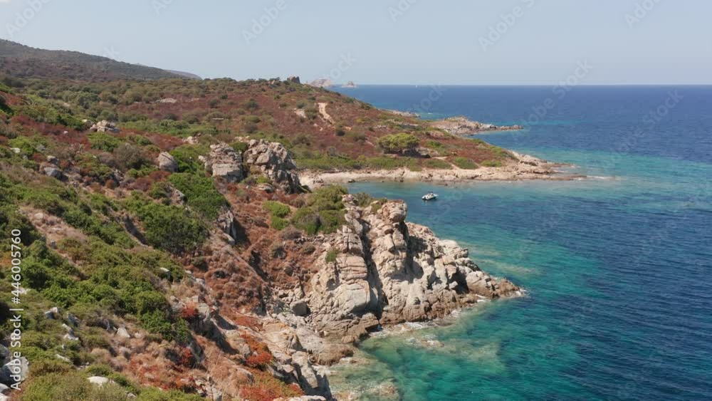 Aerial view of white rock, hills with arid vegetation, sand beach, waves crushing on the beach. Colored sea, blue turquoise, green bushes of vegetation. Aerial view of white rock, hills with arid vegetation, sand beach, waves crushing on the beach. Colored sea, blue turquoise, green bushes of vegetation.