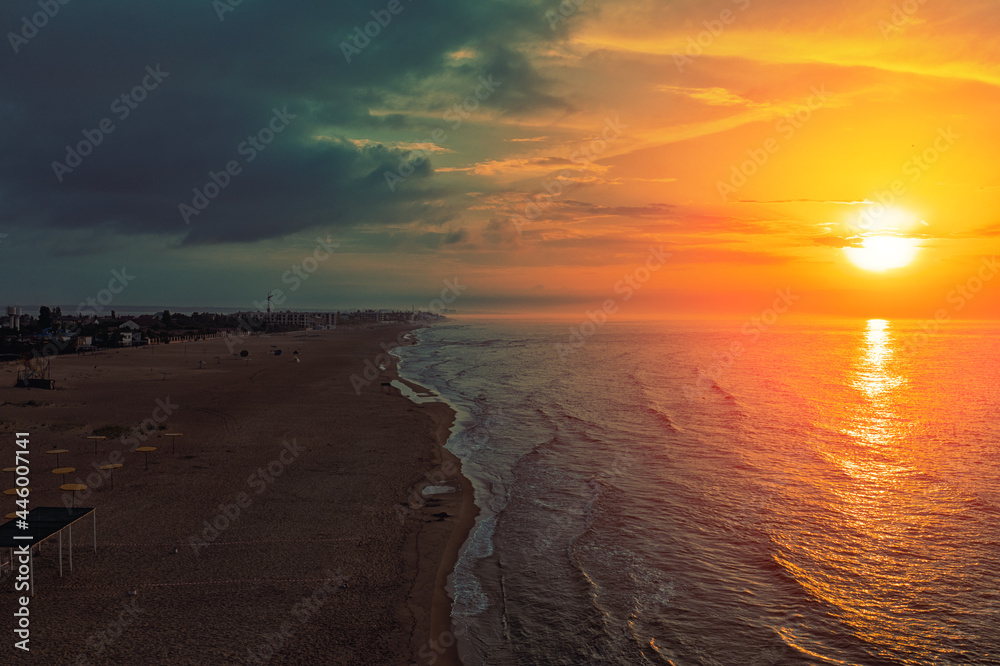 Seascape in the early morning. Sunrise over the sea. Calm sea with beautiful sky. Nature landscape. Sandy beach in summer