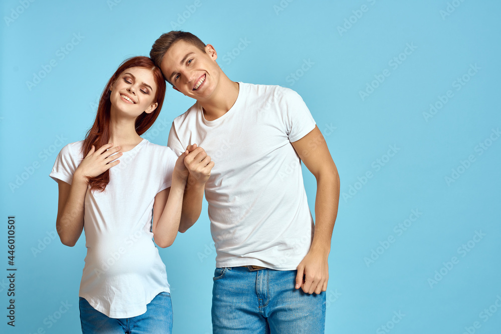 Fototapeta premium young couple pregnant wife family blue background