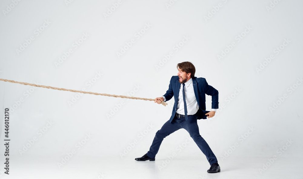 business man in suit pulling rope Studio team work business man in suit pulling rope Studio team work