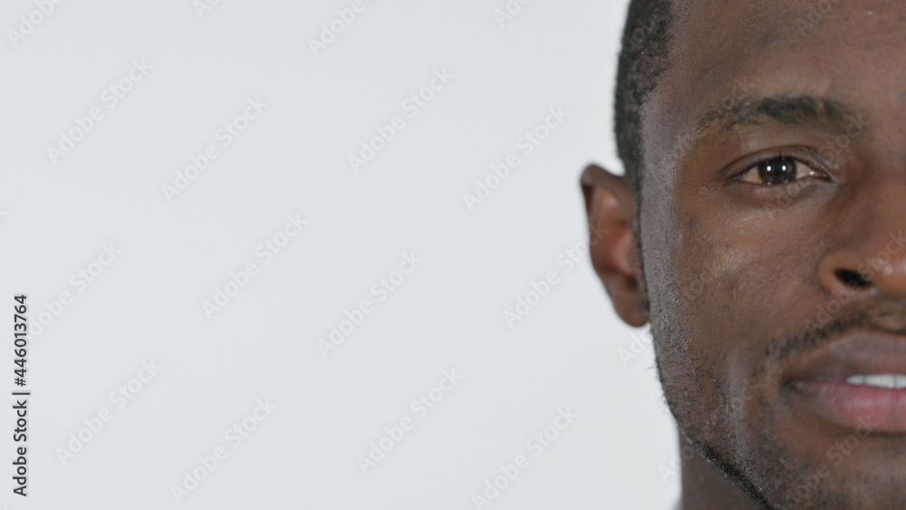 Fototapeta premium Half Face of Young African Man, White Background 