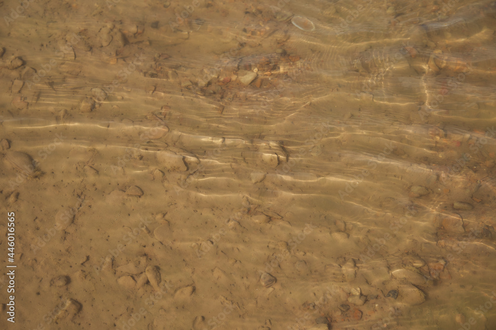 Sandy beach. River sand. Small waves on the river Sandy beach. River sand. Small waves on the river