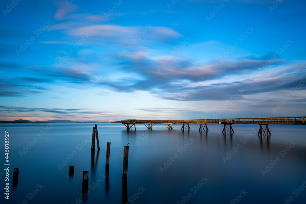 Beautiful shot of a bridge leads to the sea in Sidney Pier, Sidney, Vancouver Island, BC Canada
