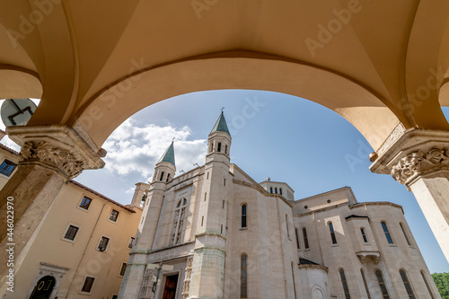 The ancient Basilica of Santa Rita framed by an arch, Cascia, Italy