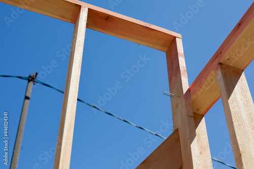 Elements of a frame building under construction. Outdoor construction. Rough pine boards in antiseptic and fireproof impregnation.
