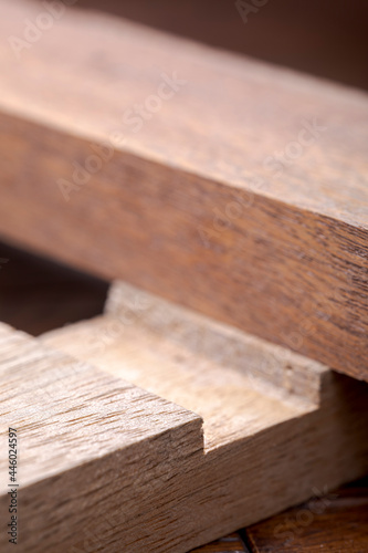 Wooden planks of hardwoods. Wooden blocks with a locksmith connection. Abstract wooden shapes.