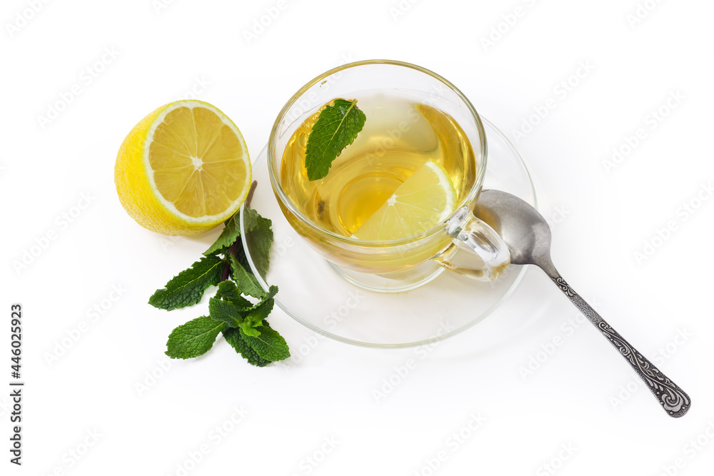 Tea with mint and lemon in glass cup on saucer