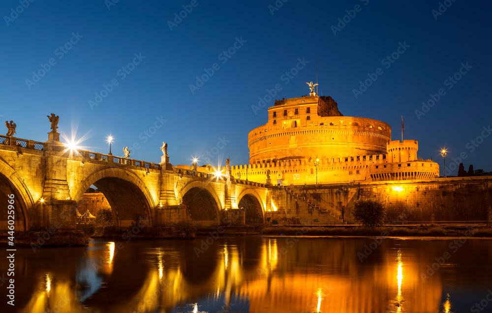 View of the Castel Sant'Angelo, the Bridge of Sant'Angelo and their reflection in the water of the Tiber River late in the evening, Rome, Italy