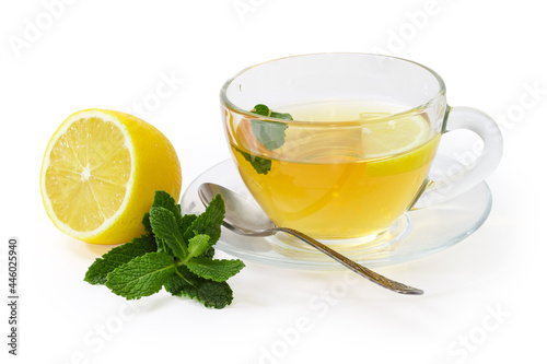 Tea with mint and lemon in glass cup on saucer