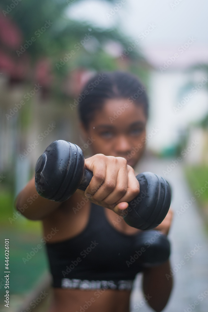 Young lady using a dumbbell