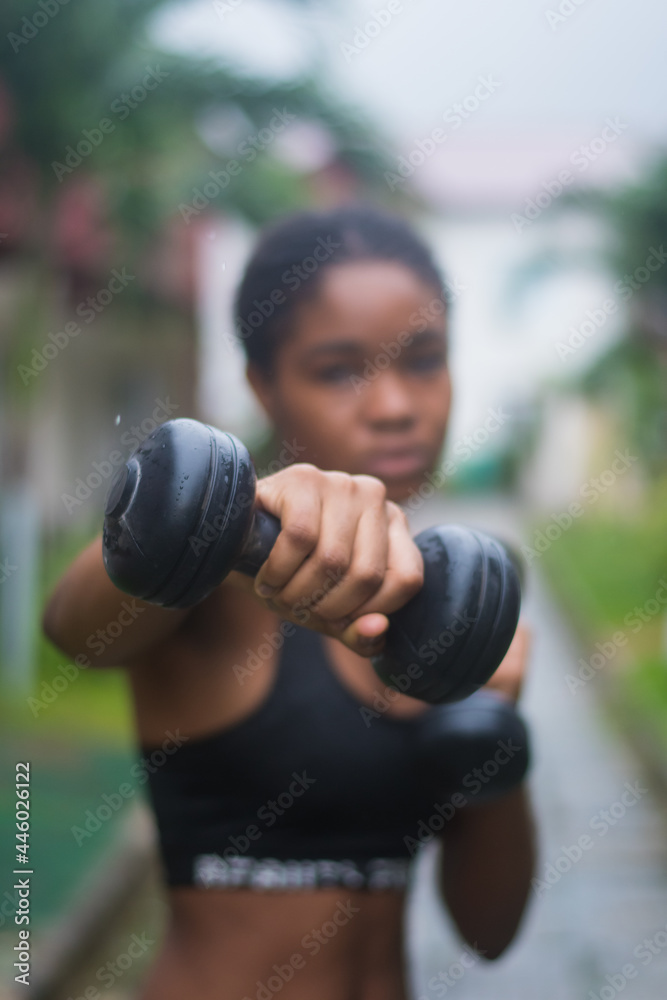 Young lady using a dumbbell Young lady using a dumbbell