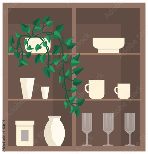 Cupboard with glass and porcelain dishes. Plates, glasses, cups and vases on shelves of wooden cabinet. Wooden furniture, interior elements with decorations. Cupboard with crockery and houseplants