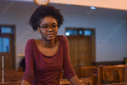 African girl with afro, in a cathedral