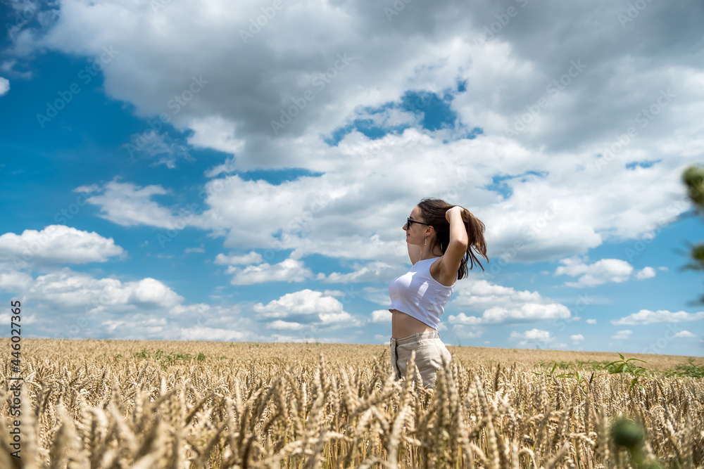 Portrait of charming young woman in golden cereal field Portrait of charming young woman in golden cereal field