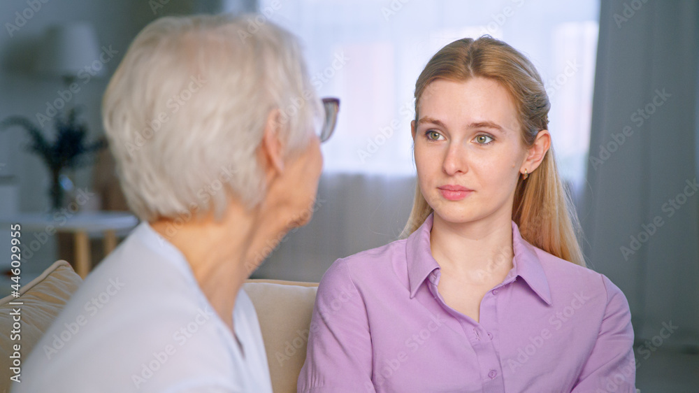 Women of different ages talking on the couch Women of different ages talking on the couch