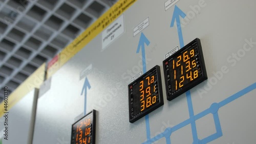 Black screens with glowing digits on control panel in electricity production substation workshop premise close view photo