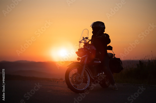 Driver riding motorcycle on an empty road