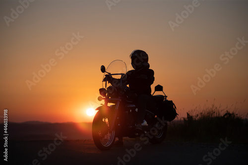 Driver riding motorcycle on an empty road