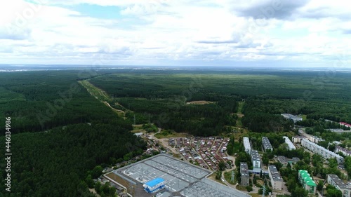 Electricity production substation with contemporary equipment on switchyard between green forest and city aerial view photo