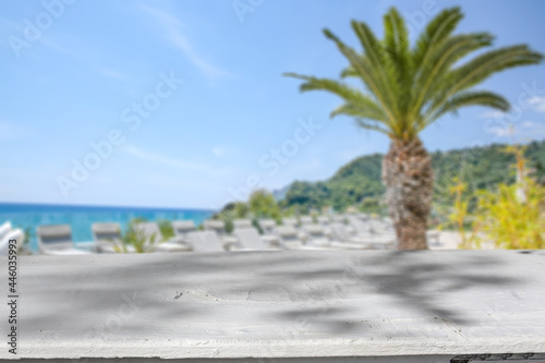 White wooden desk of free space and summer landscape of beach 