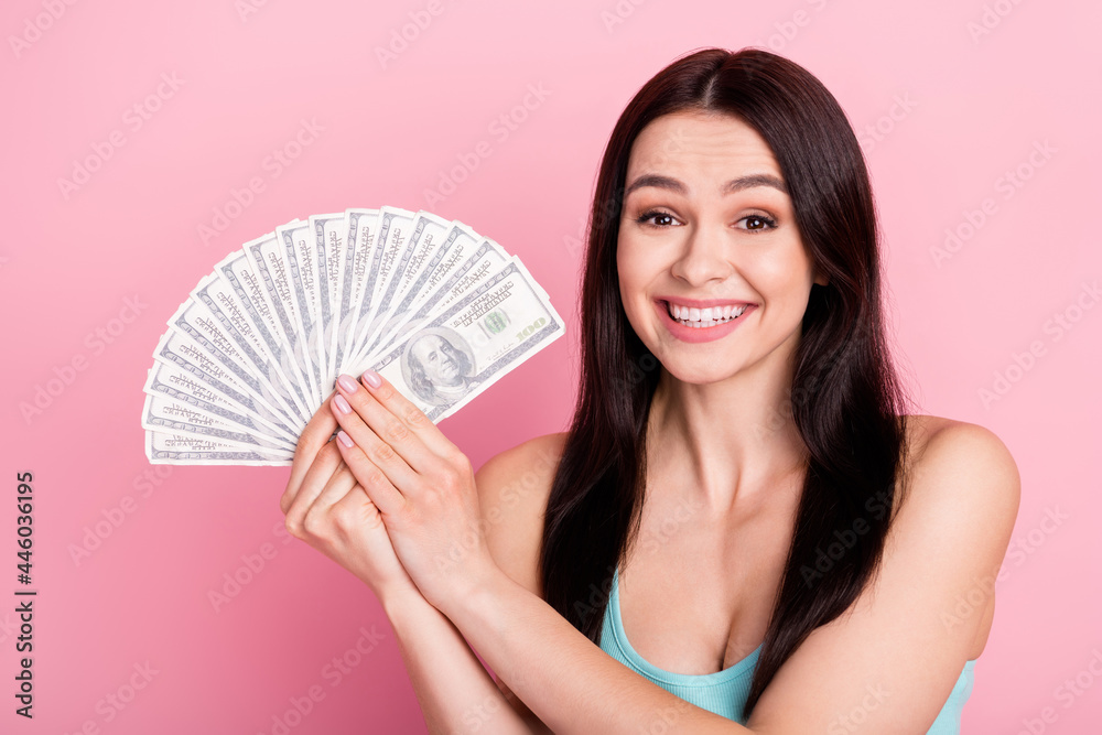 Photo of rich hooray millennial lady show money wear blue top isolated on pink color background Photo of rich hooray millennial lady show money wear blue top isolated on pink color background
