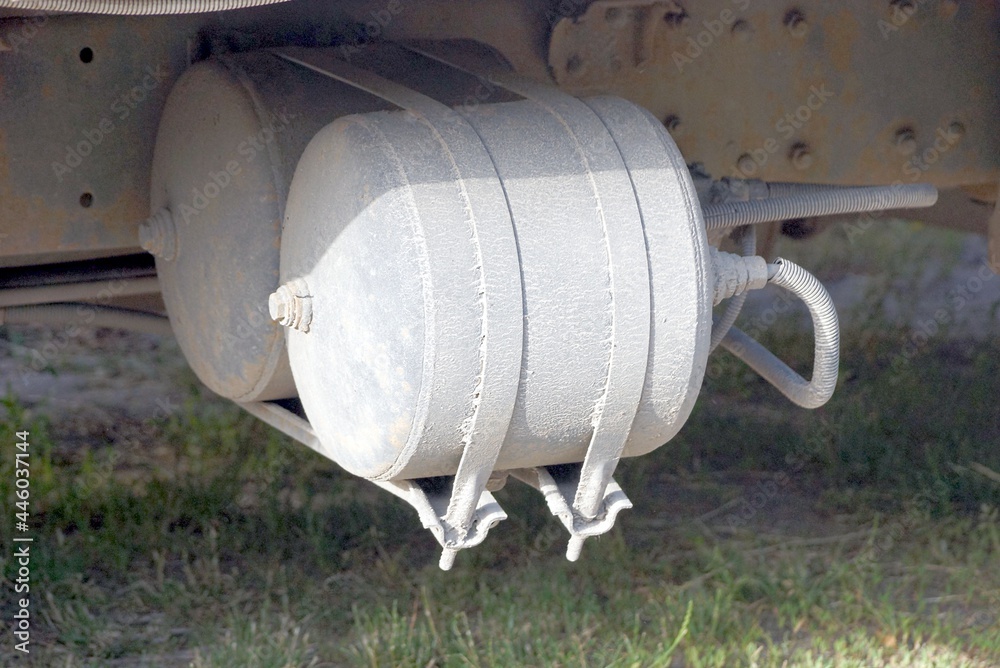 one gray metal gas tank on a truck on the street one gray metal gas tank on a truck on the street