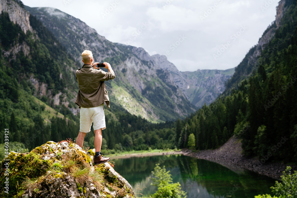 Traveler man relaxing with view mountains and lake landscape Traveler man relaxing with view mountains and lake landscape