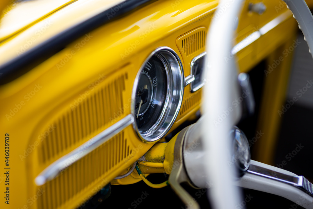 Restored yellow classic car interior. Photo taken in natural light.