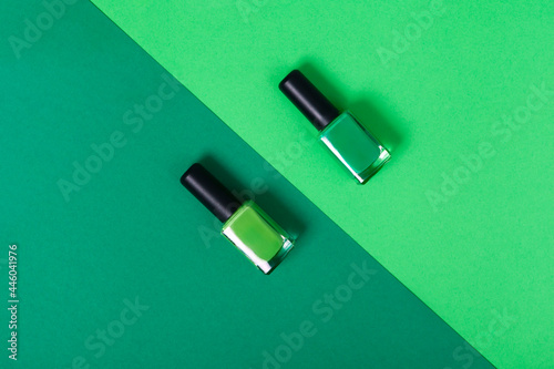 top view green nail polish 2 shades with background of the same color