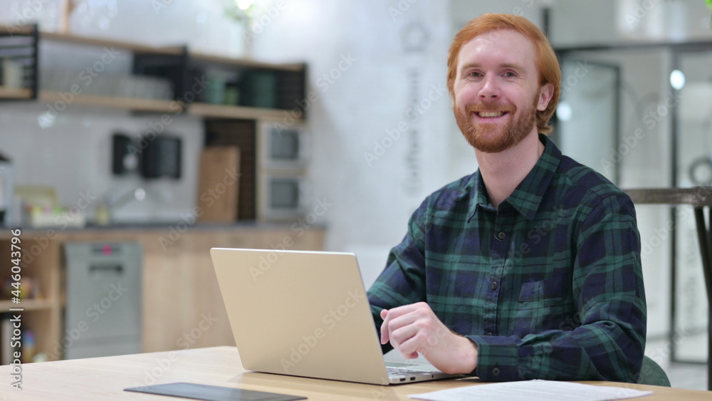 Redhead Man with Laptop Smiling at the Camera Redhead Man with Laptop Smiling at the Camera