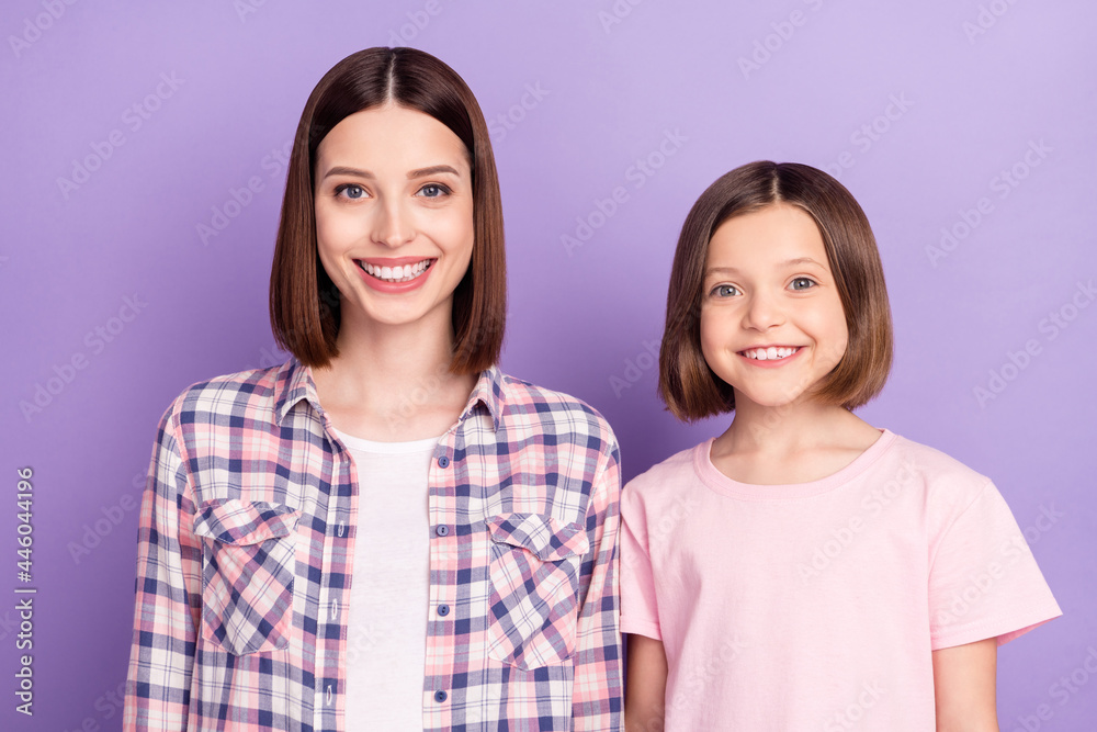 Portrait of two attractive cheerful girls best friends isolated over purple violet color background Portrait of two attractive cheerful girls best friends isolated over purple violet color background