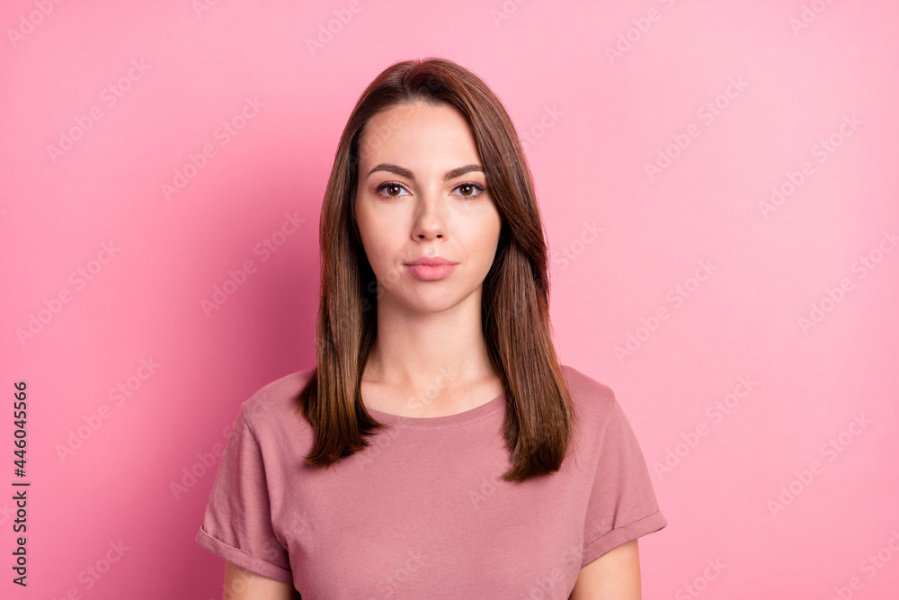 Photo of young attractive woman serious confident wear casual t-shirt isolated over pink color background Photo of young attractive woman serious confident wear casual t-shirt isolated over pink color background