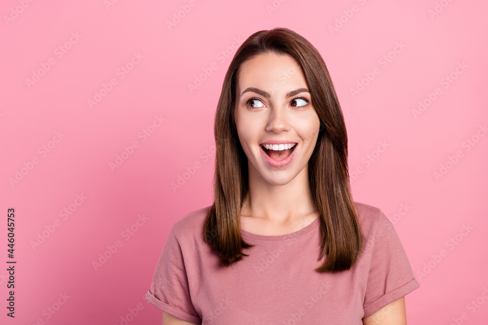 Photo of hooray brunette young lady look empty space wear t-shirt isolated on pink color background Photo of hooray brunette young lady look empty space wear t-shirt isolated on pink color background
