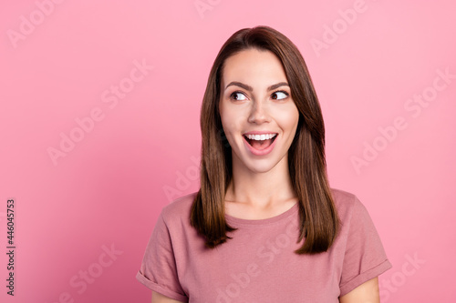 Photo of hooray brunette young lady look empty space wear t-shirt isolated on pink color background