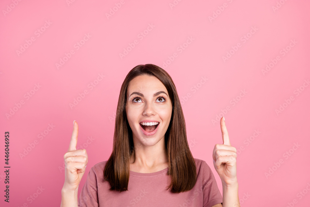 Photo of young girl amazed shocked point fingers empty space ad advice direct isolated over pink color background Photo of young girl amazed shocked point fingers empty space ad advice direct isolated over pink color background