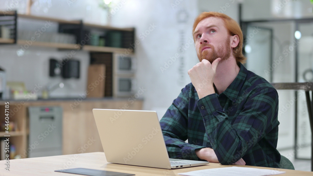 Redhead Man with Laptop Thinking in Cafe Redhead Man with Laptop Thinking in Cafe