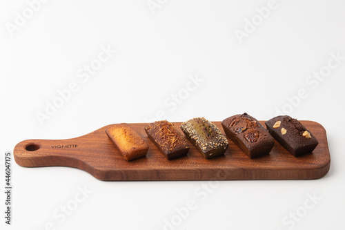 Delicious bread on a wooden cutting board with a white background.