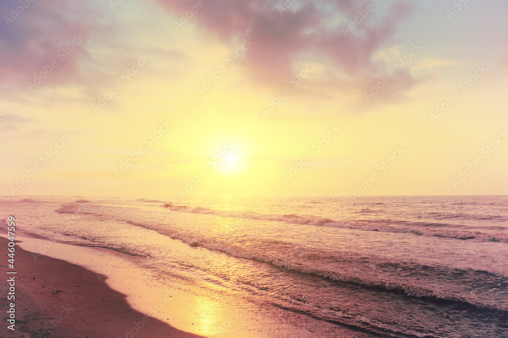 Seascape in the early morning. Sunrise over the sea with beautiful sky. Nature landscape. Sandy beach in summer