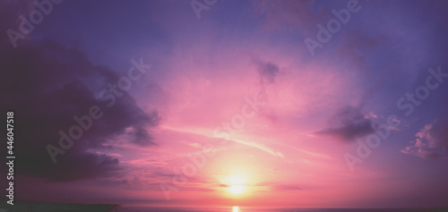 Horizontal panorama of a dramatic glowing cloudy sky at sunset. Sky texture. Abstract nature background