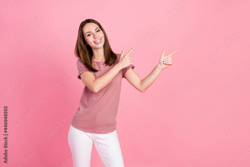 Portrait of attractive cheerful girl demonstrating copy blank space ad advert isolated over pink pastel color background Portrait of attractive cheerful girl demonstrating copy blank space ad advert isolated over pink pastel color background