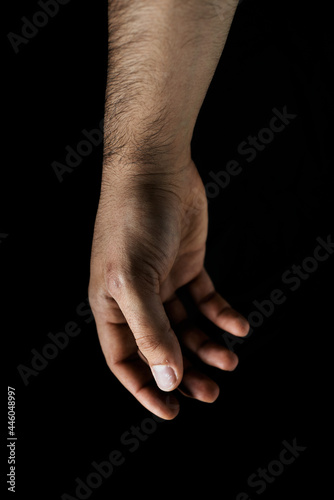 man's hand on black background