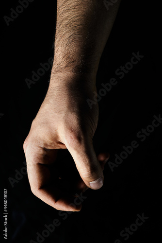 man's hand on black background