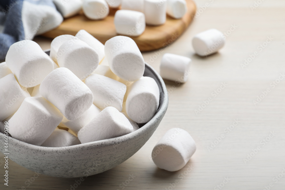 Delicious puffy marshmallows on wooden table, closeup