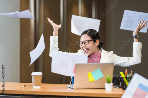 фотографія Asian businesswoman angry throwing papers over the herself in office when job fa