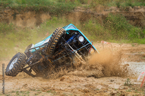 Off-road car crossing mud obstacle
