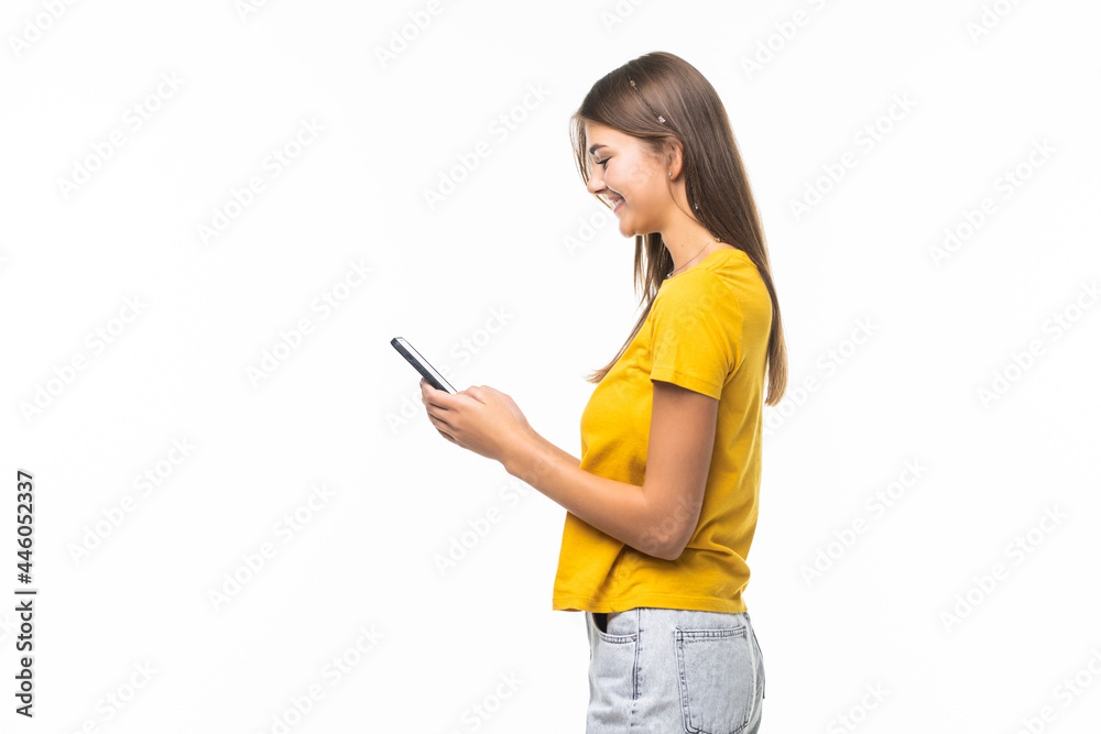 Beautiful girl sending a message with a mobile phone in a white isolated background Beautiful girl sending a message with a mobile phone in a white isolated background