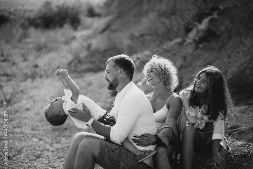 Family alltogether having fun in a sandy quarry photo